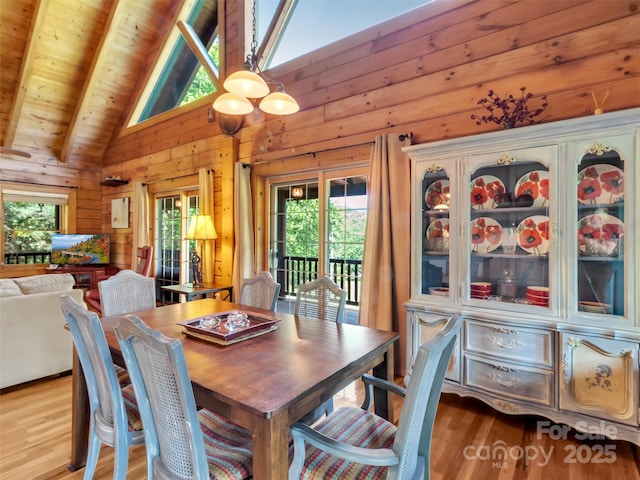 32 Tibi Ln, Waynesville, NC 28785 - dining area with plenty of natural light, wooden walls, wood finished floors, wood ceiling with exposed beams, and high vaulted ceiling