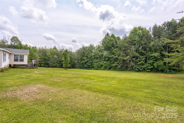 4630 Irish Potato Rd, Kannapolis, NC 28083 - view of grassy yard featuring a wooden deck and a forest view