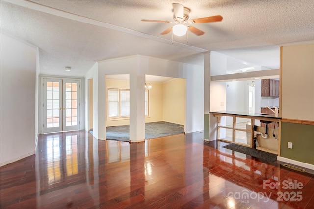 4630 Irish Potato Rd, Kannapolis, NC 28083 - empty room with wood finished floors, a textured ceiling, a ceiling fan, baseboards, and french doors