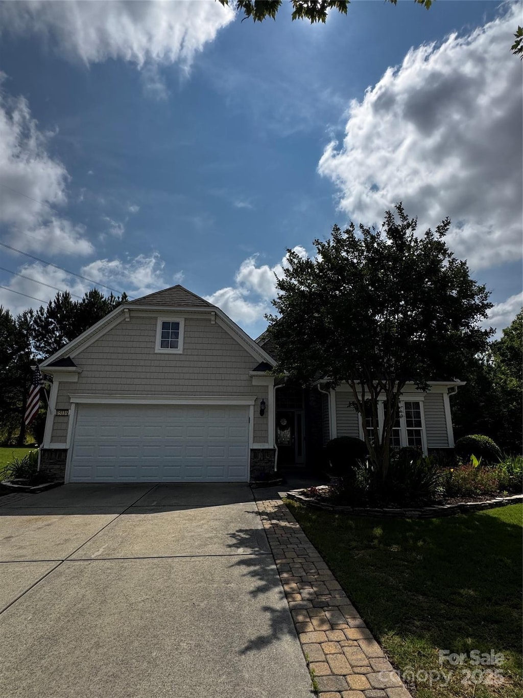 15116 Legend Oaks Ct, Fort Mill, SC 29707 - craftsman house featuring driveway, stone siding, and an attached garage