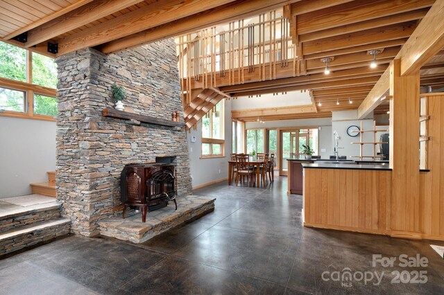 588 Long Branch Rd, Swannanoa, NC 28778 - living room with a wood stove, baseboards, and beamed ceiling