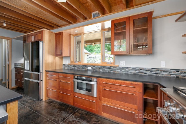588 Long Branch Rd, Swannanoa, NC 28778 - kitchen with appliances with stainless steel finishes, dark countertops, brown cabinets, glass insert cabinets, and decorative backsplash