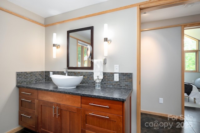 588 Long Branch Rd, Swannanoa, NC 28778 - ensuite bathroom with vanity, decorative backsplash, and baseboards