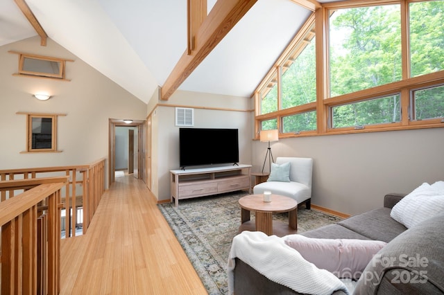 588 Long Branch Rd, Swannanoa, NC 28778 - living area with baseboards, high vaulted ceiling, beam ceiling, and light wood-style flooring