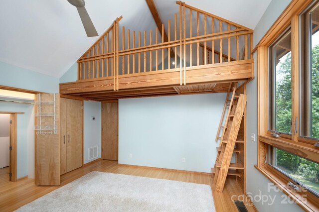 588 Long Branch Rd, Swannanoa, NC 28778 - unfurnished bedroom featuring wood finished floors and high vaulted ceiling