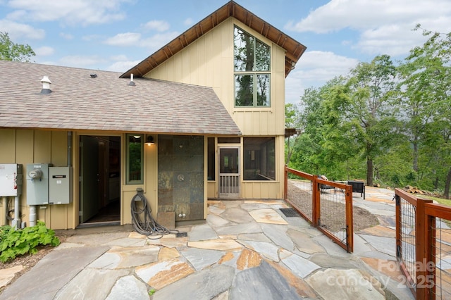 588 Long Branch Rd, Swannanoa, NC 28778 - rear view of property featuring a shingled roof, a sunroom, a patio, and board and batten siding