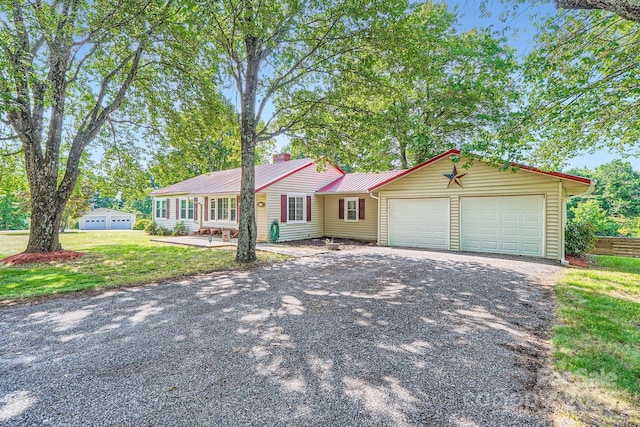 8255 Castor Rd, Salisbury, NC 28146 - ranch-style house featuring asphalt driveway, an attached garage, a chimney, metal roof, and a front lawn