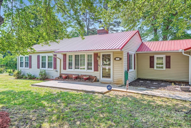 8255 Castor Rd, Salisbury, NC 28146 - ranch-style house featuring a chimney, a front yard, metal roof, and a patio