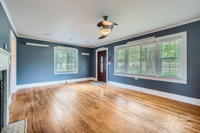 8255 Castor Rd, Salisbury, NC 28146 - unfurnished living room featuring plenty of natural light, ornamental molding, light wood-style floors, a fireplace, and baseboards