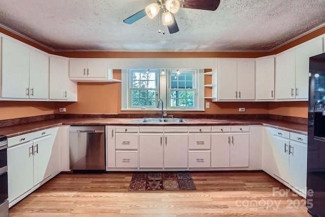 8255 Castor Rd, Salisbury, NC 28146 - kitchen featuring a sink, dishwasher, a textured ceiling, dark countertops, and white cabinetry
