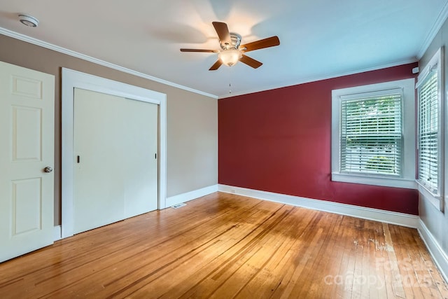 8255 Castor Rd, Salisbury, NC 28146 - unfurnished bedroom featuring hardwood / wood-style flooring, baseboards, crown molding, a closet, and a ceiling fan