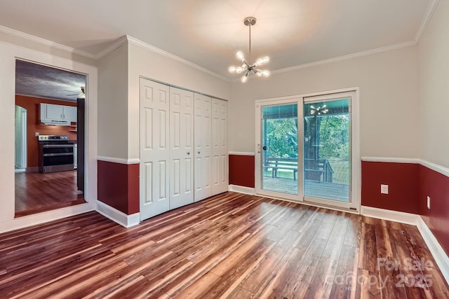 8255 Castor Rd, Salisbury, NC 28146 - unfurnished dining area with wood finished floors, baseboards, a chandelier, and ornamental molding