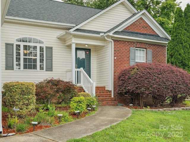 116 Birchwood Ct, Mount Holly, NC 28120 - view of front of property with a shingled roof, brick siding, and a front yard