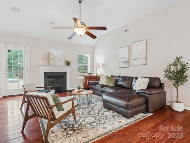 116 Birchwood Ct, Mount Holly, NC 28120 - living room featuring wood finished floors, a ceiling fan, vaulted ceiling, and a fireplace with flush hearth