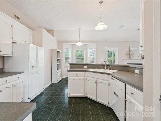 116 Birchwood Ct, Mount Holly, NC 28120 - kitchen with white appliances, white cabinets, dark countertops, and pendant lighting