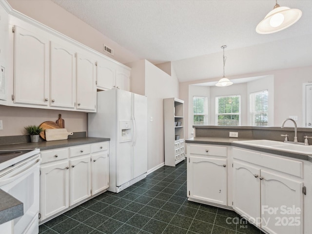 116 Birchwood Ct, Mount Holly, NC 28120 - kitchen with white appliances, white cabinetry, dark countertops, and hanging light fixtures