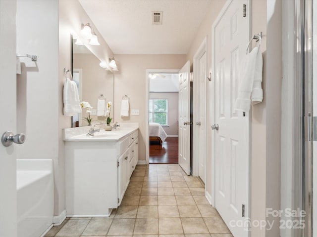 116 Birchwood Ct, Mount Holly, NC 28120 - bathroom featuring vanity, tile patterned floors, ensuite bathroom, and a bath