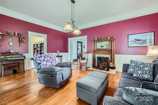 200 W 14th St, Salisbury, NC 28144 - living room featuring wainscoting, ornamental molding, light wood-style floors, and a fireplace with raised hearth