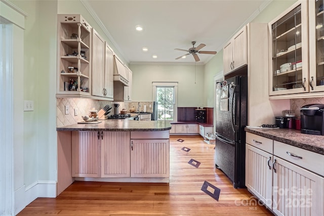200 W 14th St, Salisbury, NC 28144 - kitchen featuring freestanding refrigerator, ceiling fan, dark countertops, decorative backsplash, and a peninsula