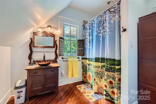 200 W 14th St, Salisbury, NC 28144 - bathroom with wood finished floors, vanity, vaulted ceiling, baseboards, and curtained shower