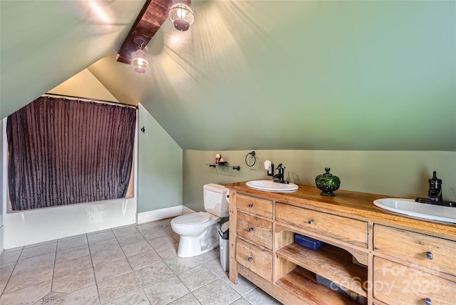 200 W 14th St, Salisbury, NC 28144 - full bath featuring toilet, lofted ceiling, tile patterned flooring, double vanity, and baseboards