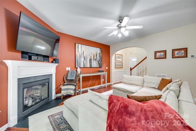 288 Sand Paver Way Unit 50, Fort Mill, SC 29708 - living area with arched walkways, a fireplace with flush hearth, ceiling fan, stairway, and wood finished floors