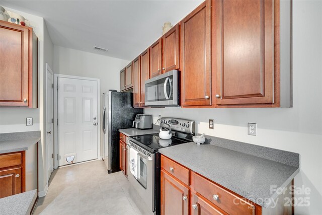 288 Sand Paver Way Unit 50, Fort Mill, SC 29708 - kitchen with stainless steel appliances and brown cabinets