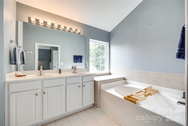 288 Sand Paver Way Unit 50, Fort Mill, SC 29708 - full bathroom with vaulted ceiling, double vanity, a bath, and tile patterned flooring