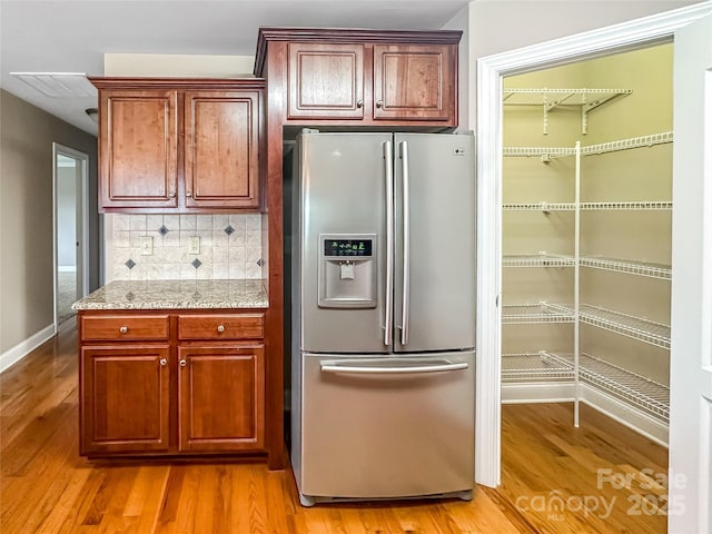1625 Damascus Cir, Conover, NC 28613 - kitchen featuring stainless steel fridge with ice dispenser, light wood-type flooring, tasteful backsplash, and baseboards