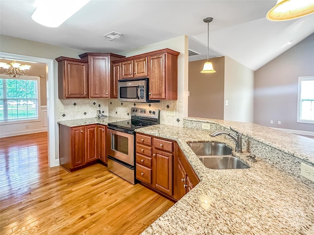1625 Damascus Cir, Conover, NC 28613 - kitchen with appliances with stainless steel finishes, a sink, light wood-type flooring, decorative backsplash, and vaulted ceiling