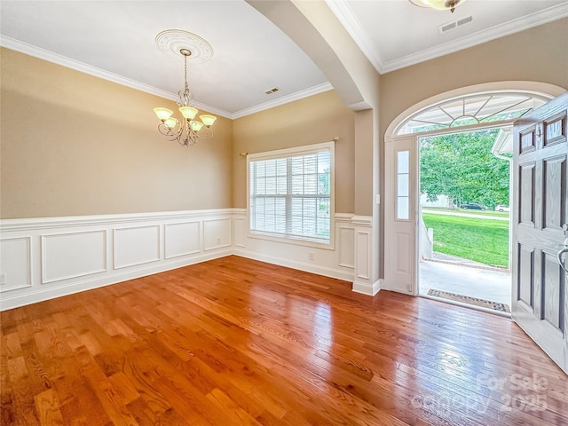 1625 Damascus Cir, Conover, NC 28613 - foyer with a chandelier, arched walkways, healthy amount of natural light, light wood-type flooring, and crown molding