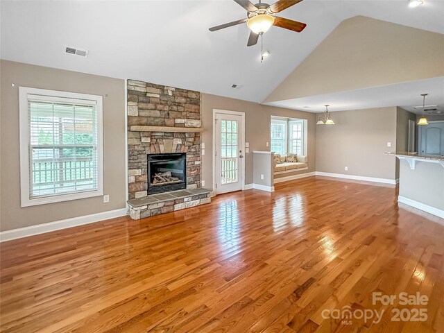 1625 Damascus Cir, Conover, NC 28613 - unfurnished living room featuring ceiling fan, a fireplace, light wood-style flooring, high vaulted ceiling, and baseboards