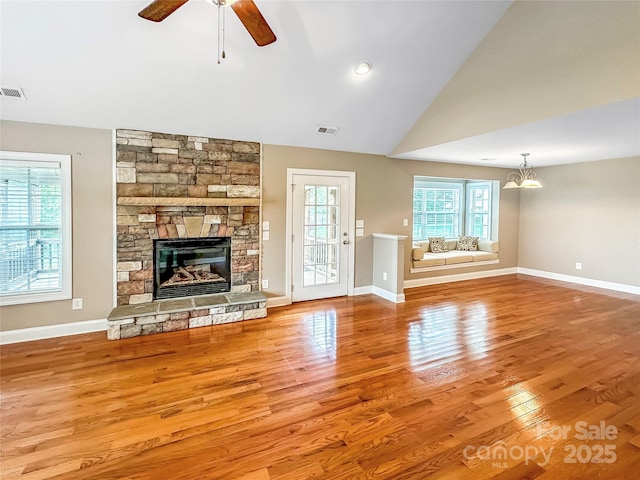 1625 Damascus Cir, Conover, NC 28613 - unfurnished living room featuring wood finished floors, a stone fireplace, a ceiling fan, baseboards, and vaulted ceiling