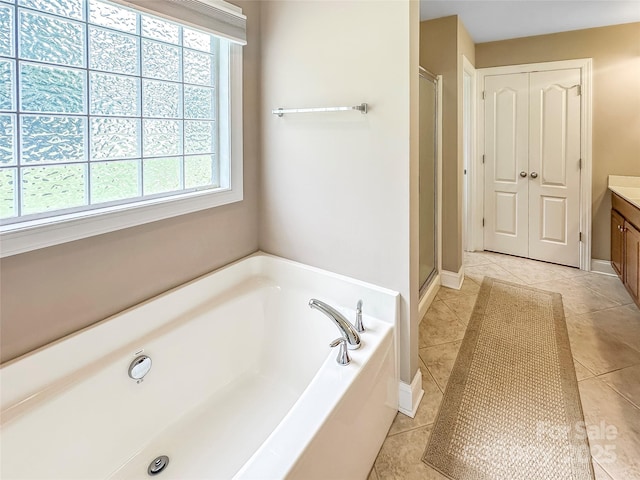 1625 Damascus Cir, Conover, NC 28613 - full bathroom featuring a garden tub, vanity, a shower stall, tile patterned floors, and baseboards