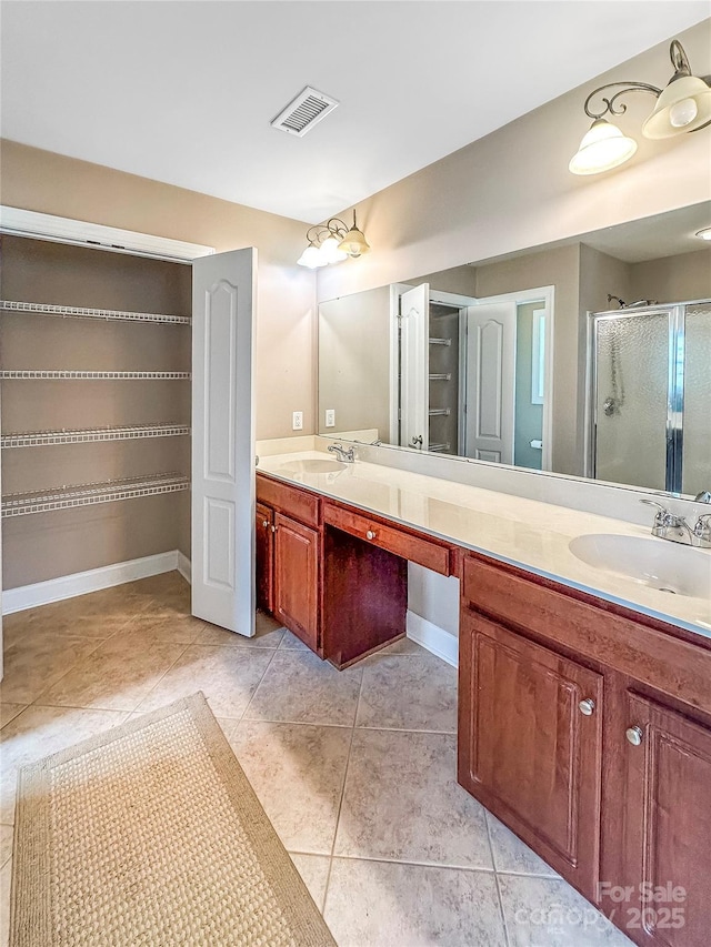 1625 Damascus Cir, Conover, NC 28613 - bathroom featuring double vanity, a shower stall, tile patterned flooring, and baseboards