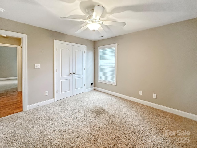 1625 Damascus Cir, Conover, NC 28613 - unfurnished bedroom featuring carpet flooring, a closet, baseboards, and ceiling fan