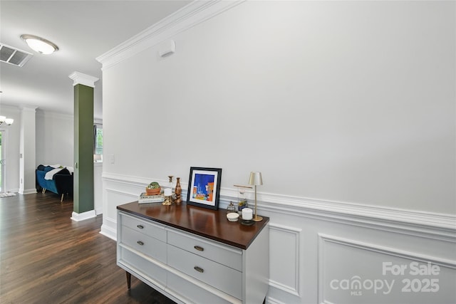 2034 Houle Ln, Charlotte, NC 28214 - corridor featuring crown molding, dark wood finished floors, a decorative wall, wainscoting, and ornate columns