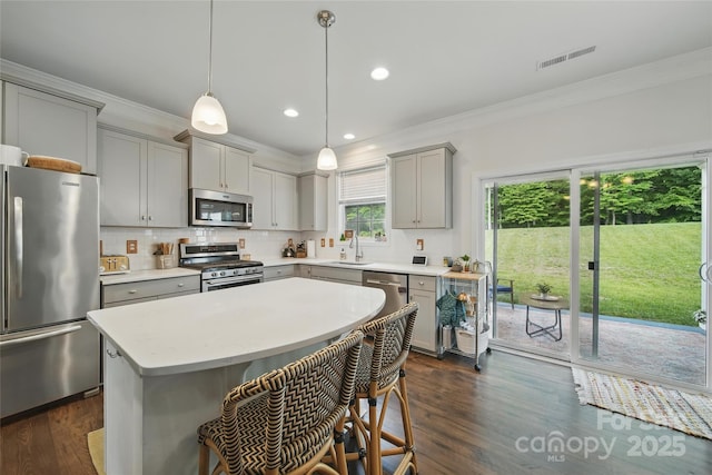 2034 Houle Ln, Charlotte, NC 28214 - kitchen featuring stainless steel appliances, gray cabinets, crown molding, light countertops, and dark wood-style flooring