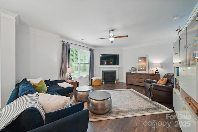 2034 Houle Ln, Charlotte, NC 28214 - living area featuring wood finished floors, a ceiling fan, ornamental molding, a glass covered fireplace, and baseboards