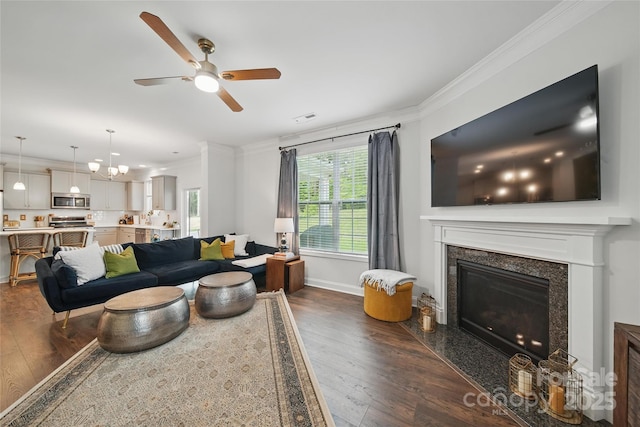 2034 Houle Ln, Charlotte, NC 28214 - living area with dark wood finished floors, a ceiling fan, ornamental molding, a fireplace, and baseboards