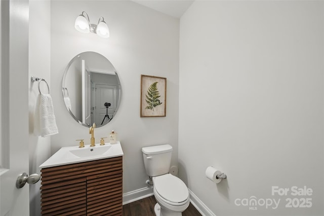 2034 Houle Ln, Charlotte, NC 28214 - half bathroom with toilet, wood finished floors, vanity, and baseboards