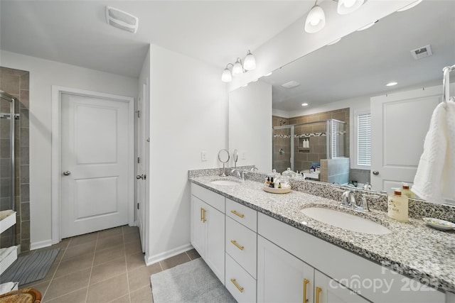 2034 Houle Ln, Charlotte, NC 28214 - bathroom featuring double vanity, a shower stall, tile patterned flooring, and baseboards