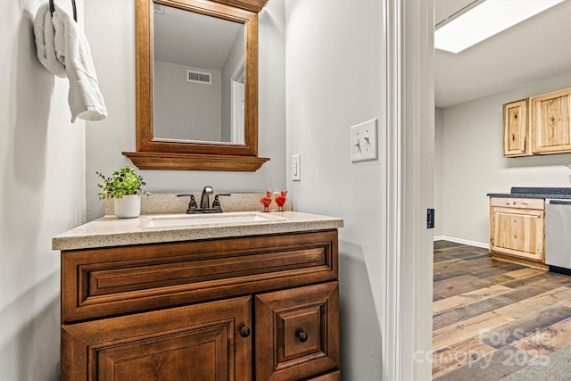 729 Tenth Ave NE, Hickory, NC 28601 - bathroom featuring vanity, wood finished floors, and baseboards