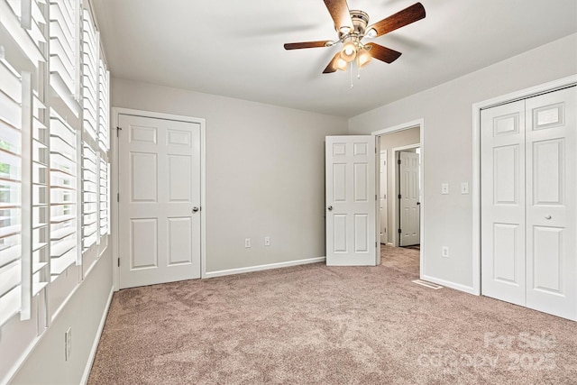 729 Tenth Ave NE, Hickory, NC 28601 - unfurnished bedroom featuring multiple windows, light colored carpet, and a closet