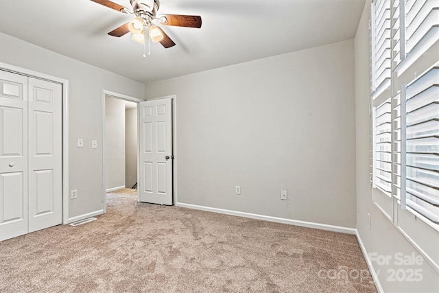 729 Tenth Ave NE, Hickory, NC 28601 - unfurnished bedroom featuring light carpet, baseboards, a closet, and a ceiling fan