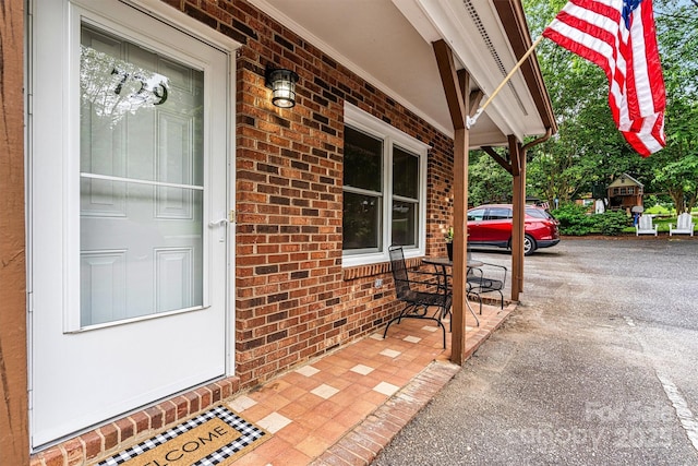 729 Tenth Ave NE, Hickory, NC 28601 - doorway to property featuring covered porch and brick siding