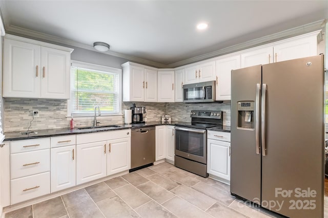 1645 Brookdale Ave, Charlotte, NC 28210 - kitchen featuring appliances with stainless steel finishes, crown molding, white cabinets, tasteful backsplash, and dark stone countertops