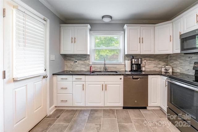 1645 Brookdale Ave, Charlotte, NC 28210 - kitchen featuring appliances with stainless steel finishes, white cabinetry, tasteful backsplash, crown molding, and dark stone counters