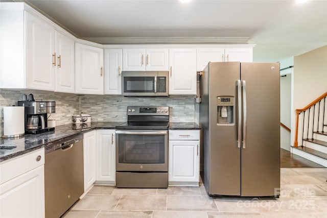 1645 Brookdale Ave, Charlotte, NC 28210 - kitchen with stainless steel appliances, white cabinetry, tasteful backsplash, and dark stone countertops