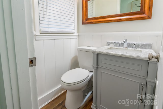 1645 Brookdale Ave, Charlotte, NC 28210 - half bath featuring vanity, a wainscoted wall, and wood finished floors